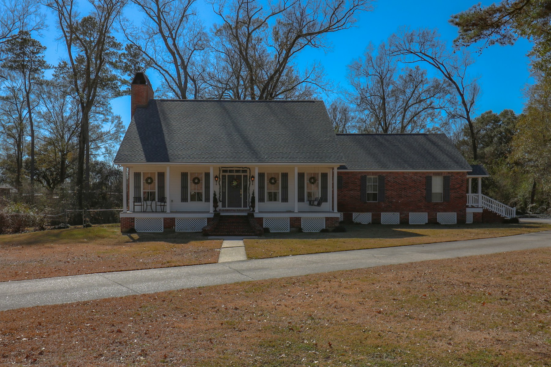 A welcoming American home surrounded by mature trees